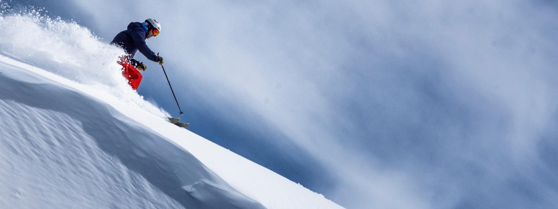 Woman skiing downhill Woman going down a downhill fast
