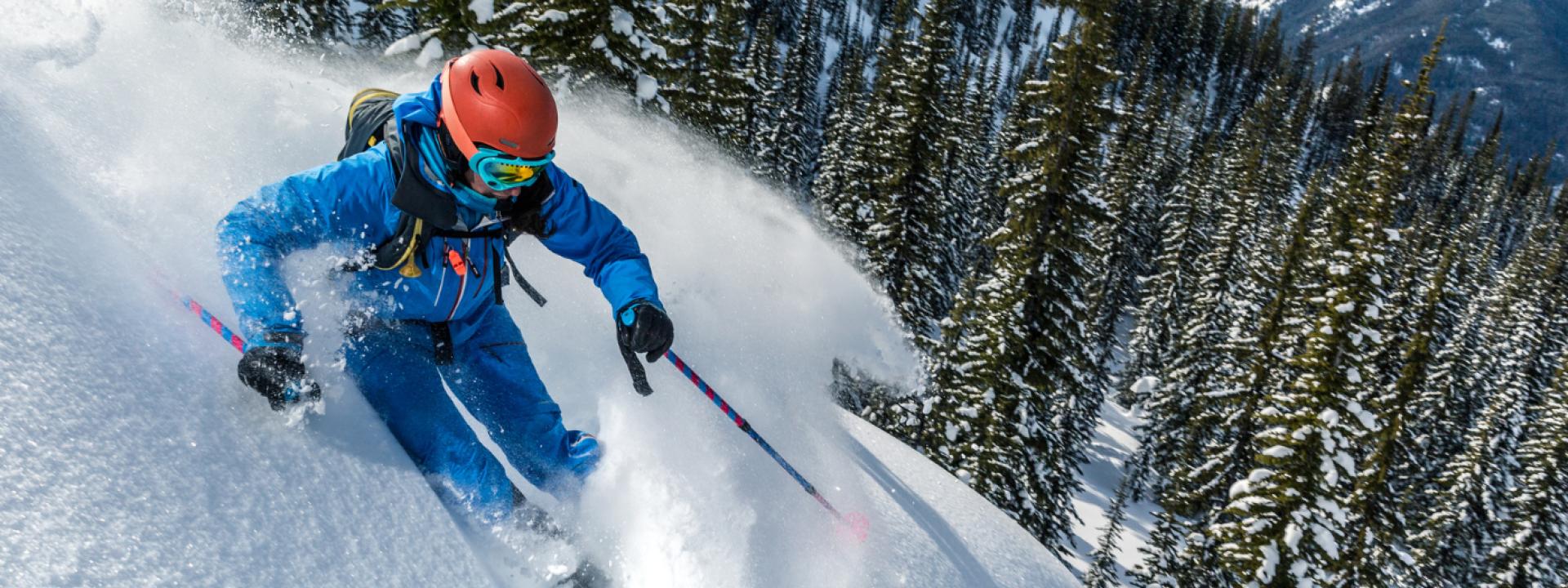 woman skiing in forrest woman going downhill in forrest