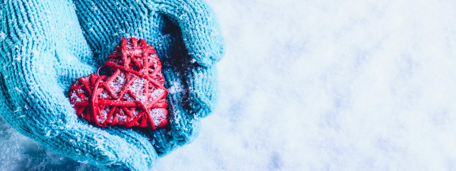 New year, fresh start Hands with gloves holding a heart