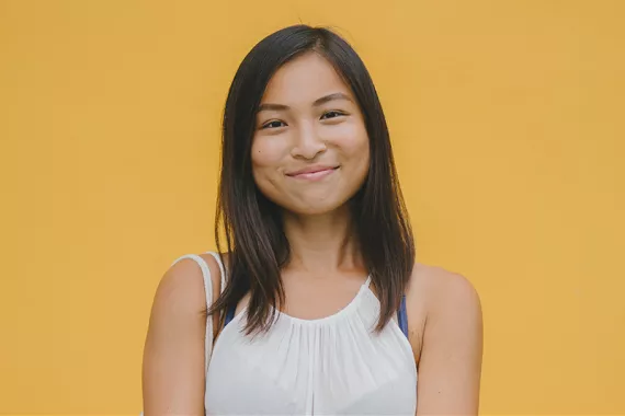 Smiling woman with orange background