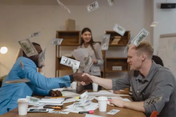 Money flying around in a room